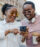 Two young woman smiling while looking at a cell phone